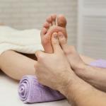 close-up-hands-massaging-sole